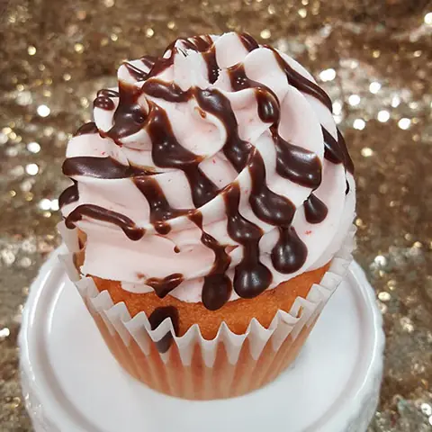A chocolate drizzle cupcake