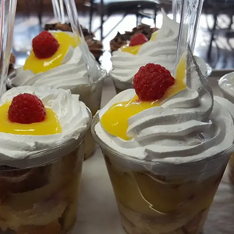 Cupcake cups layered with lemon curd and raspberries