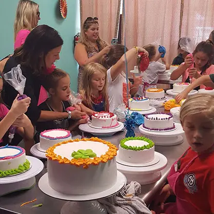 Kids showing off their finished cakes