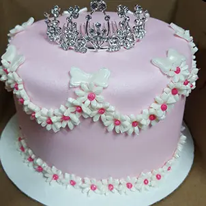 A pink princess cake with a tiara
