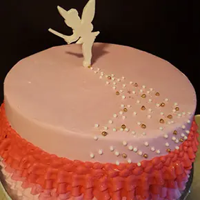 A peach ombre cake with a fairy silhouette