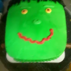 A green monster face cake