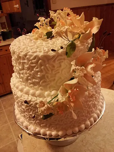 A textured buttercream cake with fall sugar flowers
