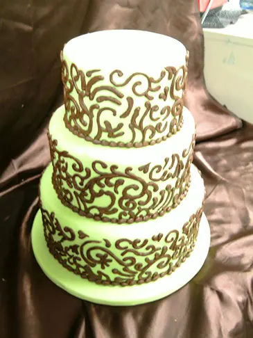 Black scrollwork on green and white tiers