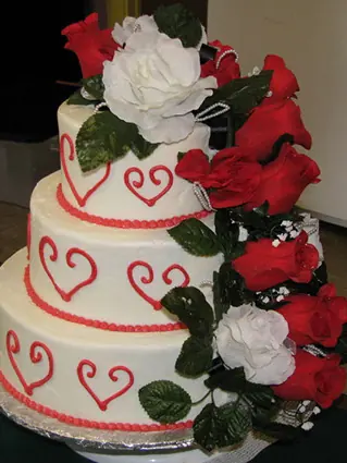 White tiers with red hearts and red roses