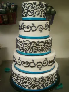 Round tiers with teal ribbon and chocolate scrollwork