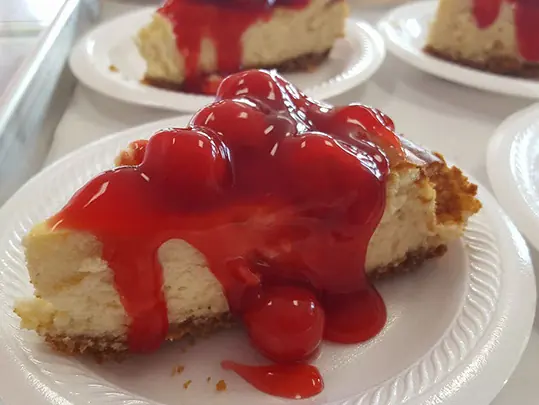 A slice of cherry cheesecake on a plate
